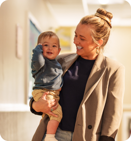 A woman carrying a toddler boy.