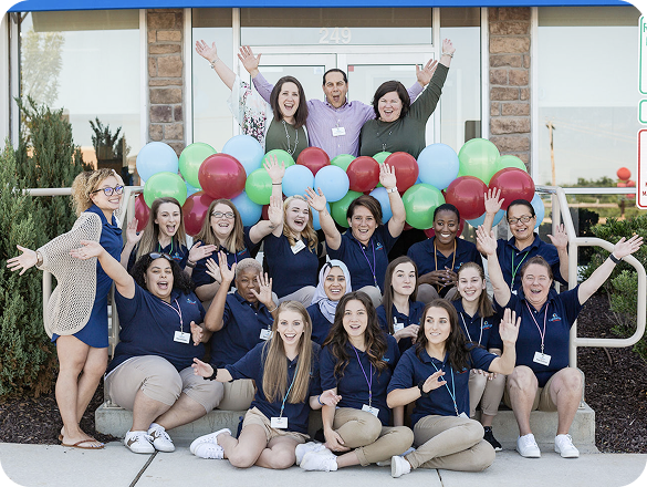 A group of Lightbridge Academy staff members celebrating.