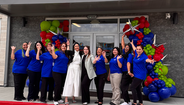 A group of people celebrating the opening of a Lightbridge Academy.