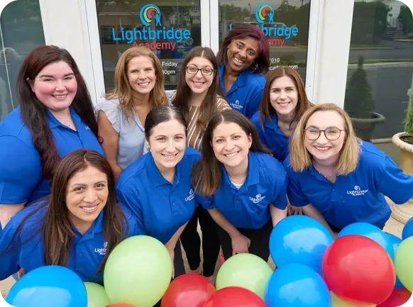 A Lightbridge Academy franchise owner and team members celebrating a location opening.