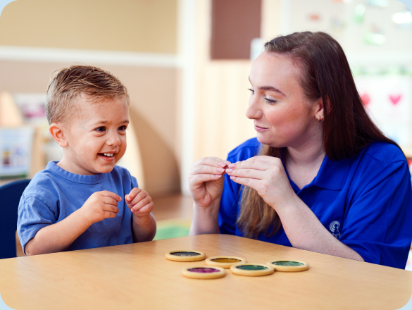 Teacher playing a learning game with a young child