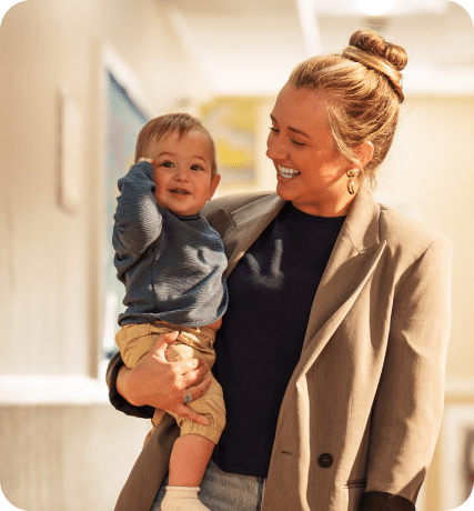 A woman carrying a toddler boy.