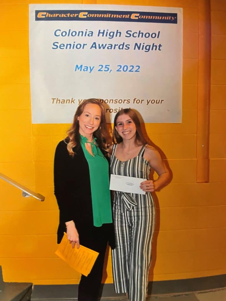 Two women with a donation check.