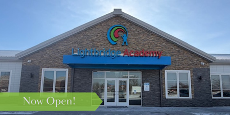 Photo of a Lightbridge Academy Center with the words Now Open