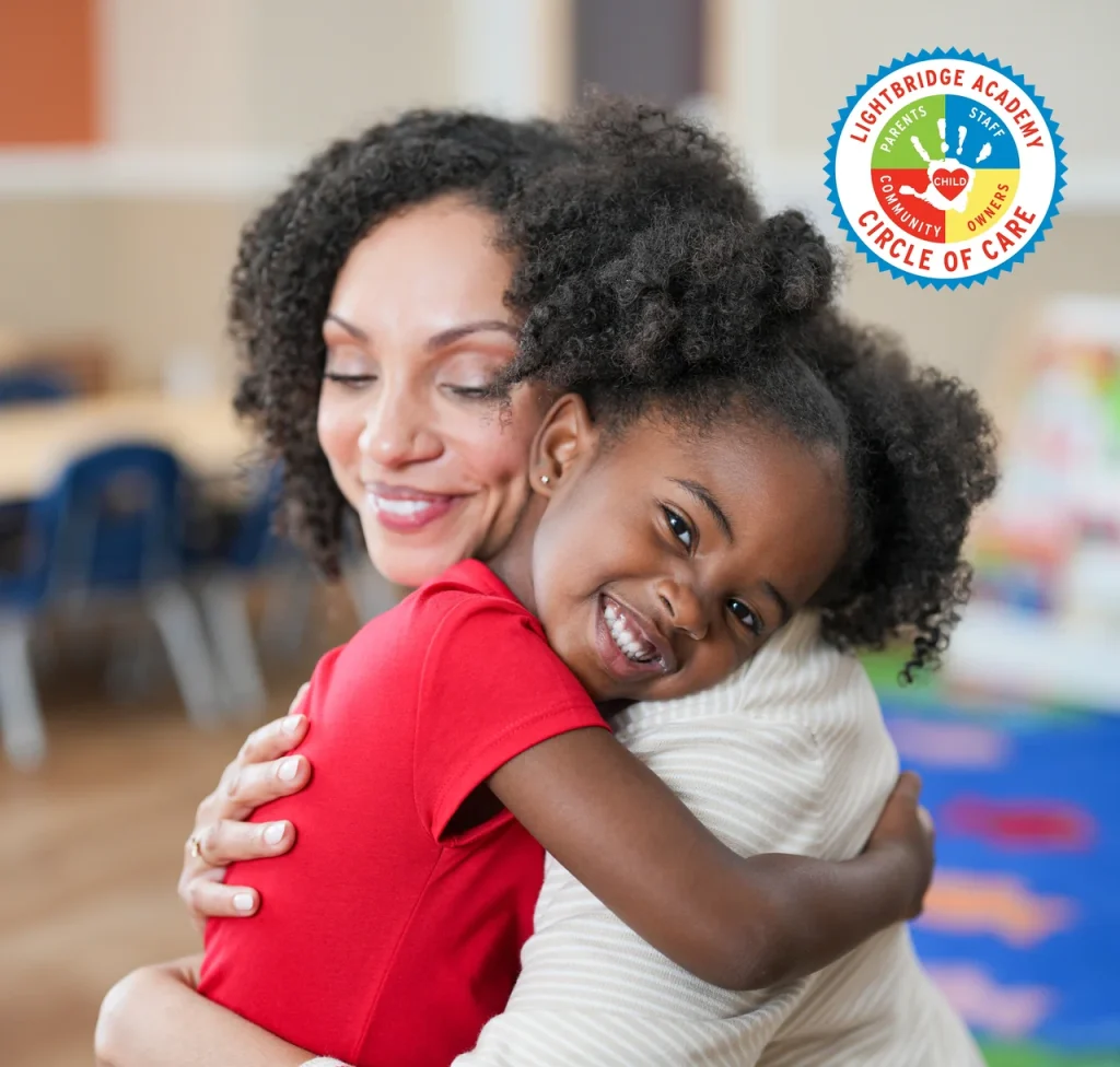 A mother hugging her daughter in a daycare classroom.