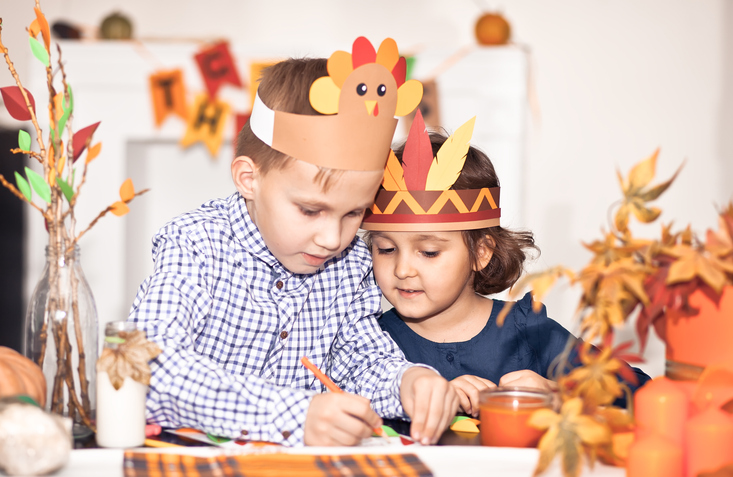 Children creating Thanksgiving crafts.