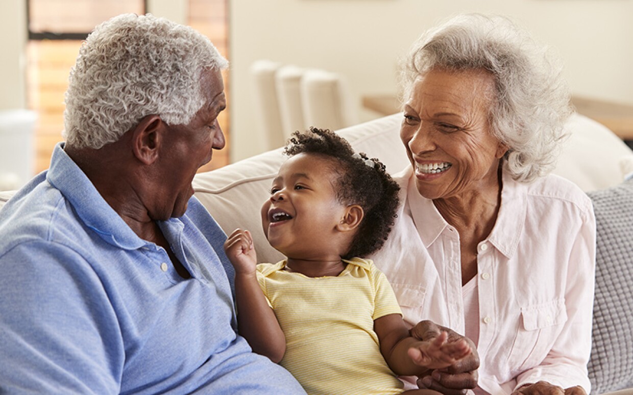 Young child smiling at her grandparents