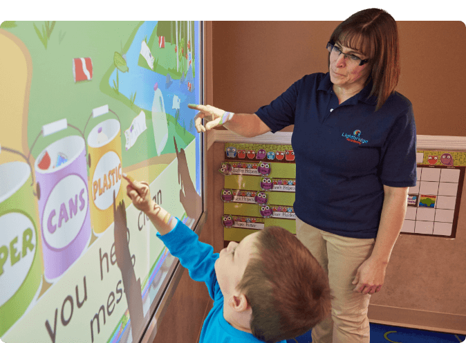 teacher works with student on kindergarten readiness