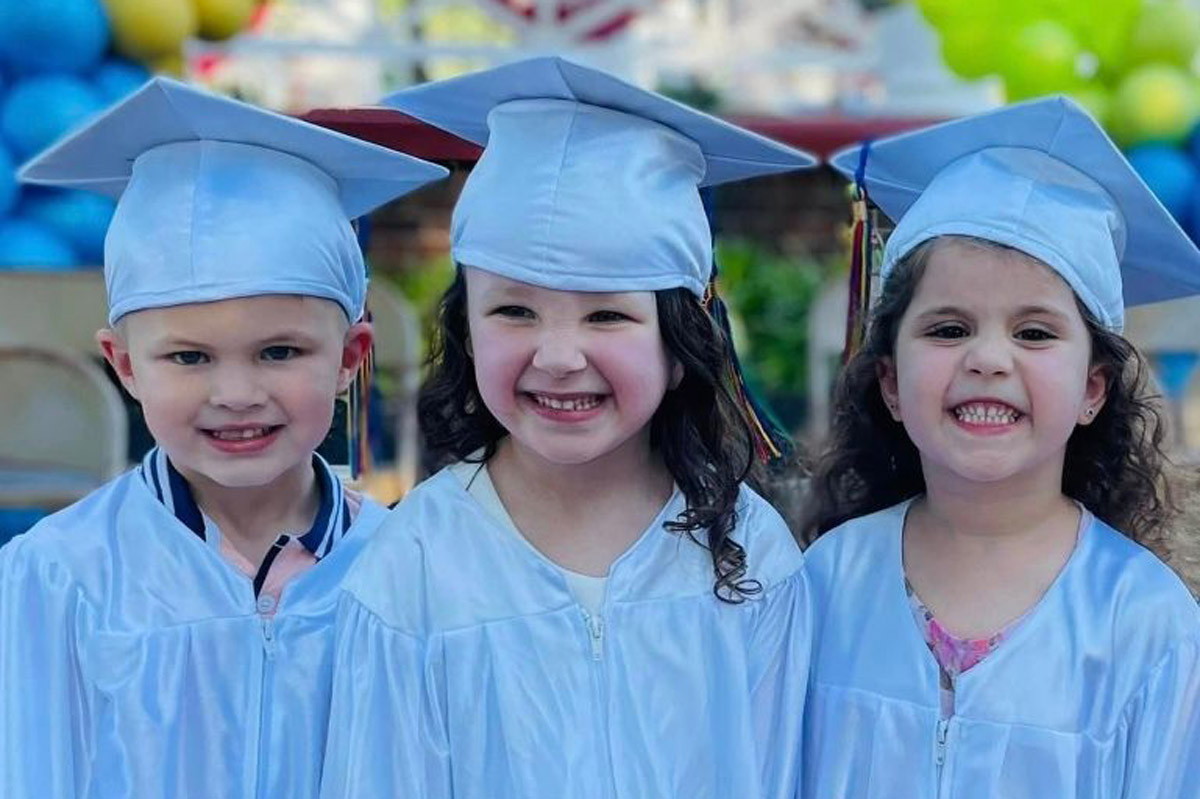 Graduating young kids posing for a photo